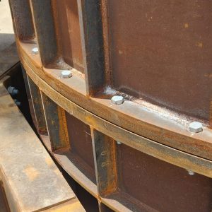 Metal beams bolted together at a construction site.